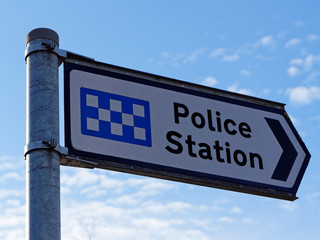 Naklejka premium A signpost indicates the police station in United Kingdom