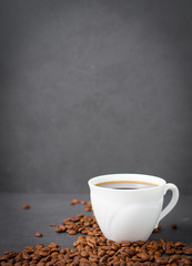 Obraz na płótnie Canvas Cup of coffee against aged dark gray wall