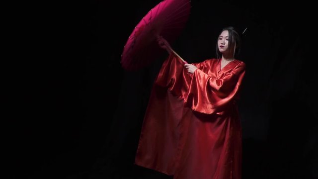Asian girl opens and puts an umbrella on her shoulder while smiling, slow motion