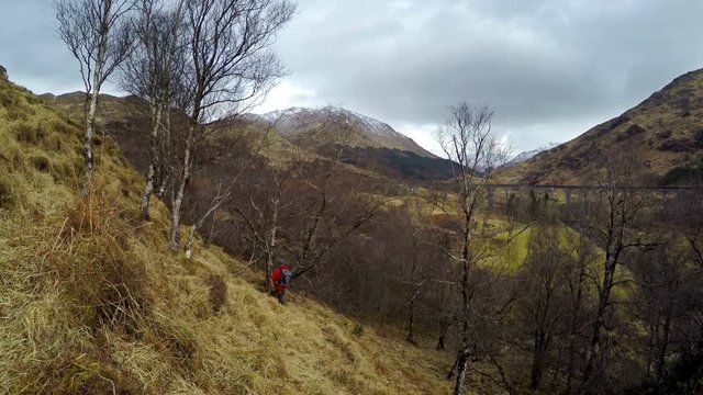 4K footage of a traveler exploring the hills of Scotland
