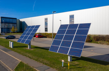 solar panels in front of a factory building
