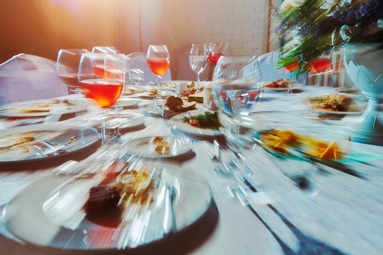 Banquet table with food, as he sees a drunk man, an alcoholic who drank a lot of alcoholic beverages