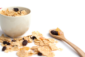whole grain cereal flakes which mixed berry fruit and raisins for breakfast isolated on white background