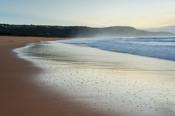 Sunrise at Kilcare Beach,Ausralia. Reflections, waves sand on the Central Coast, New South Wales