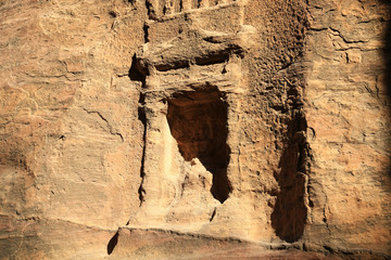 Rock-cut remains in Siq - long narrow passage, gorge that leads to Petra, Jordan
