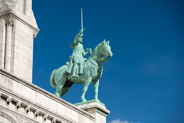 Obraz premium Statue on Basilica of the Sacred Heart of Paris or Basilica Coeur Sacre on Montmartre in Paris