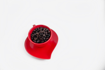 Red coffee cup empty with coffee beans. On a red plate. Coffee break