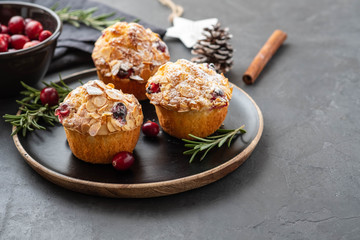 Muffins, cakes with cranberry, rosemary and almond nuts. Christmas decoration. Copy space.