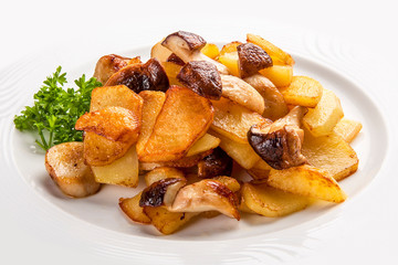 Fried potatoes with mushrooms on a white plate. Russian traditional dish