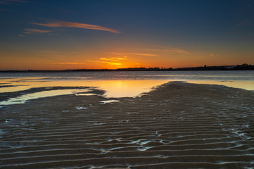 Sunset  and reflection over still water at Harrington, Australia