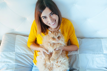 playful cat with woman at home
