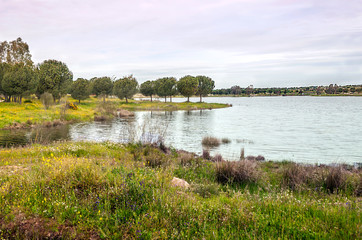 Guadiana river next to the fields of Extremadura on a sunny day