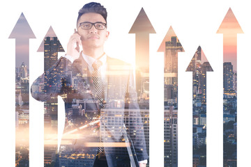 The double exposure image of the businessman using a smartphone during sunrise overlay with cityscape and  business chart image. the concept of accounting, financial, economy and investment.