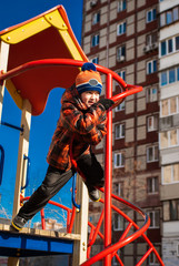 Boy has fun on the playground outdoors