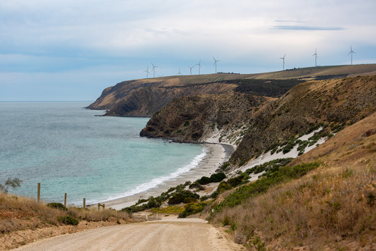 A landscape photo of Morgans Beach Cape Jervis showing the gravel access road and the starfish windfarm in the distance located in South Australia on 1st November 2018