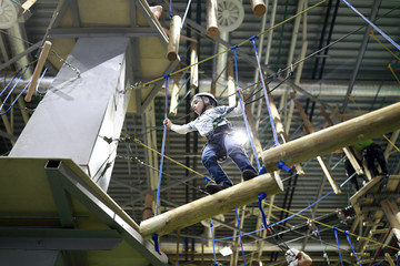 Kid climbing in rope park