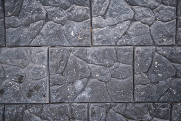 Close-up of gray wall of large stone slabs.
