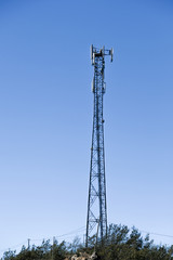 Cellular radio tower antenna. Mobile GSM Base Station Tower with blue sky.