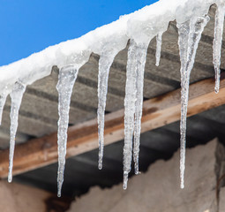 Icicles hang from the roof in winter