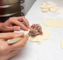 Cooking dough with meat on the table