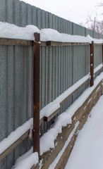 Snow on the fence in winter as a background