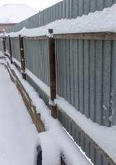 Snow on the fence in winter as a background