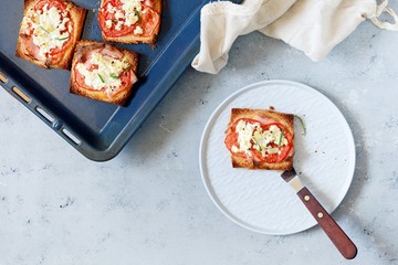 Ruddy toast with baked tomatoes, cheese and herbs. Morning breakfast. Crisp, Grilled, baked toast.