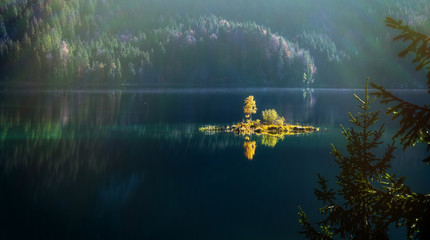 Amazing View on the Eibsee Lake. Scenic image of fairy-tale woodland in sunlit. fairy-tale woodland...