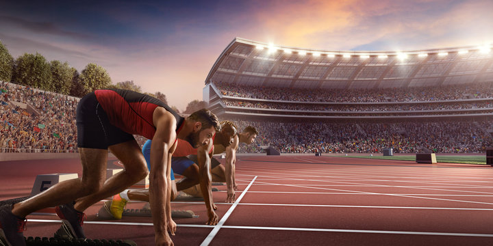 Male athletes sprinting. Three men in sport clothes on starting line prepares to run at the running track in professional stadium
