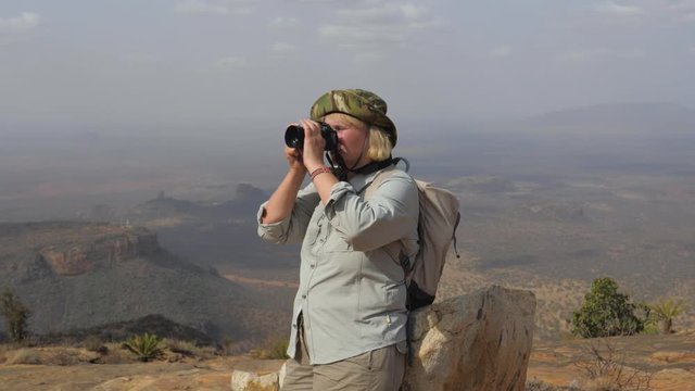 Tourist On Top Of The Mountain Takes Pictures Of The Picturesque Landscape