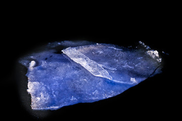 Ice floe in dark water at winter