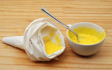 Homemade cream puffs or eclaire filled with vanilla custard cream.