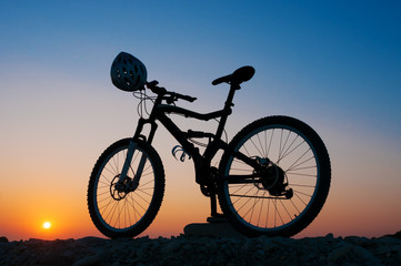Silhouette of mountain bike at sunset