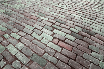 Cobblestone road. Big square stones close up. Road surface.  Selective focus