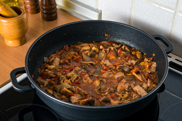 Sauce with mushrooms, prepared for pasta in a kitchen
