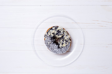 donut in sugar glaze on transparent plate