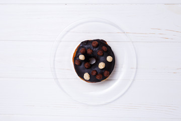 donut in sugar glaze on transparent plate
