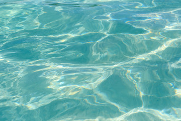 Clear water with sun glare. Close up.
