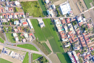 Fields with various types of agriculture and villages beside with air pollution in winter morning, Tainan, Taiwan, aerial view