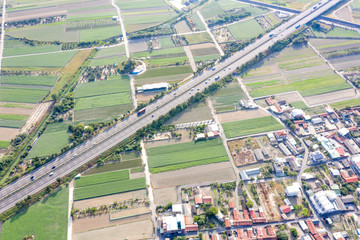 Fields with various types of agriculture and villages beside with air pollution in winter morning, Tainan, Taiwan, aerial view