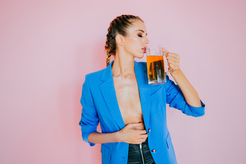 Nice girl drinking a beer. Oktoberfest Beer fest. Young sexy and naked woman, serving big mugs