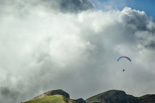Paraglider flies over the mountains