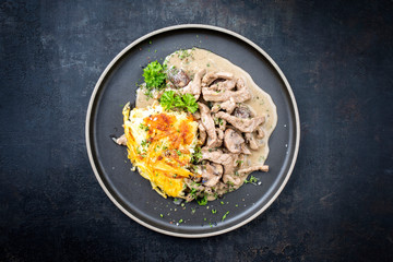 Traditional Swiss zürcher geschnetzeltes with rösti as top view in a modern style plate