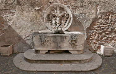 ancient fountain in Rome, Italy