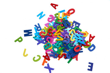 Pile of colorful wooden letters isolated over the white background with copyspace