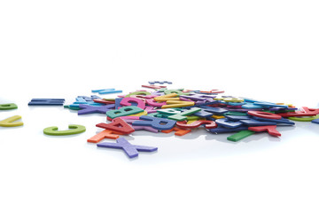 Pile of colorful wooden letters isolated over the white background with copyspace