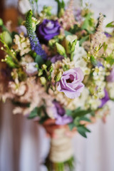 young beautiful bride in white dress holding wedding bouquet, bouquet of bride from rose purple Memory Lane, violet eustoma, eucalyptus .