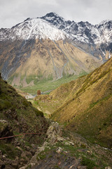 Landscape of a valley of a mountain valley, mountains with snow-capped peaks in Georgia