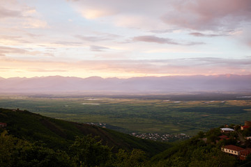 Fototapeta premium Bird eye on view on Alazani valley, clouds in the sky sunset