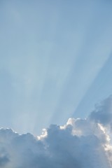 Fototapeta na wymiar blue sky sun rays from behind the clouds, Sun rays behind cloud
